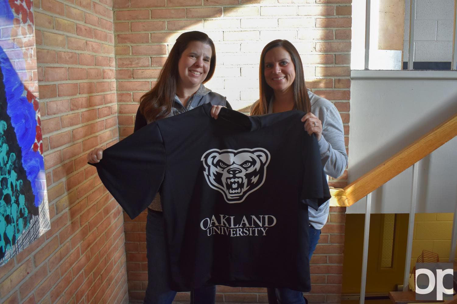 Two women holding the Oakland Shirt for Grizz